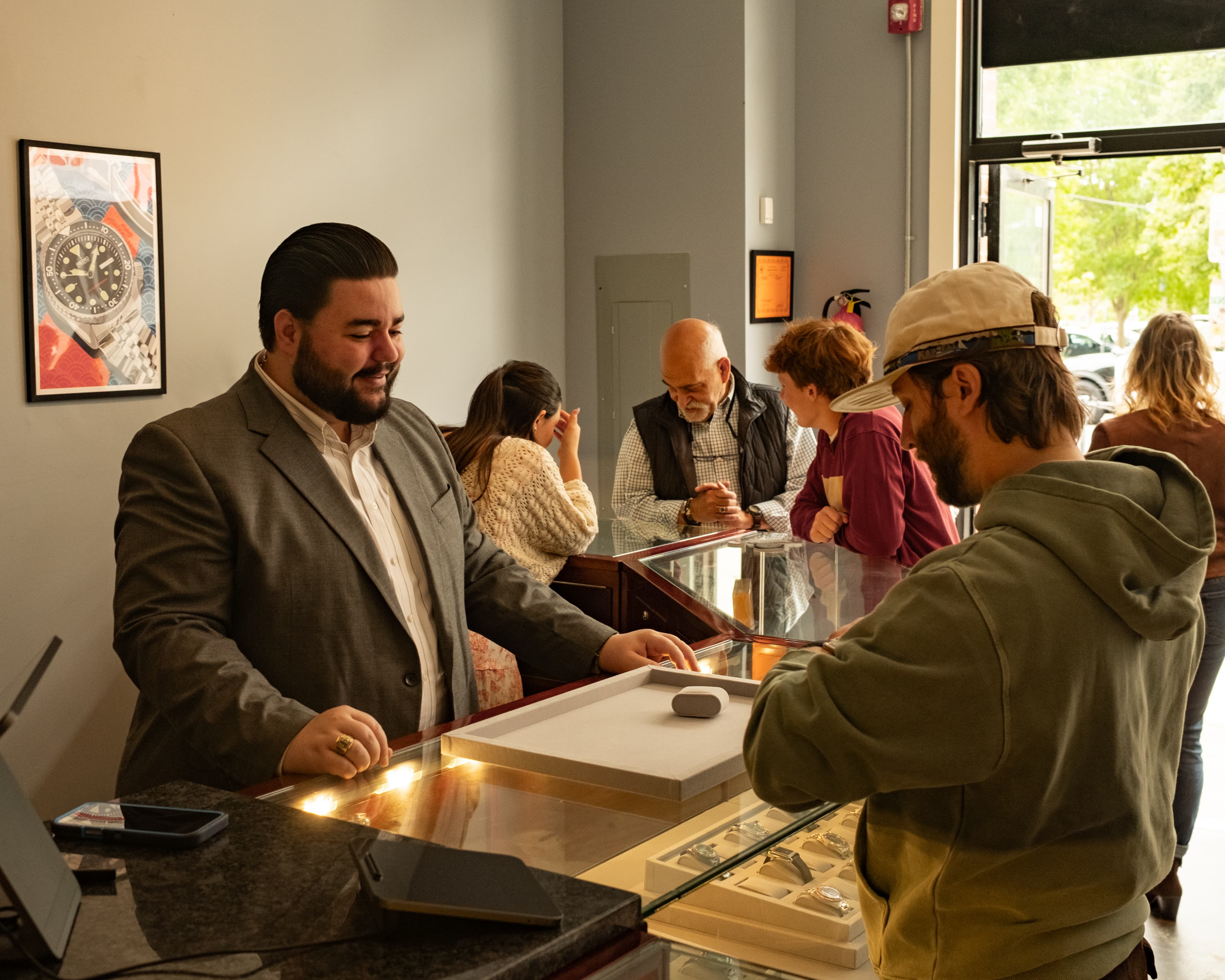 Inside Asbury Park Watches at 511 Cookman Ave, Asbury Park, NJ — a customer being helped at the display counter
