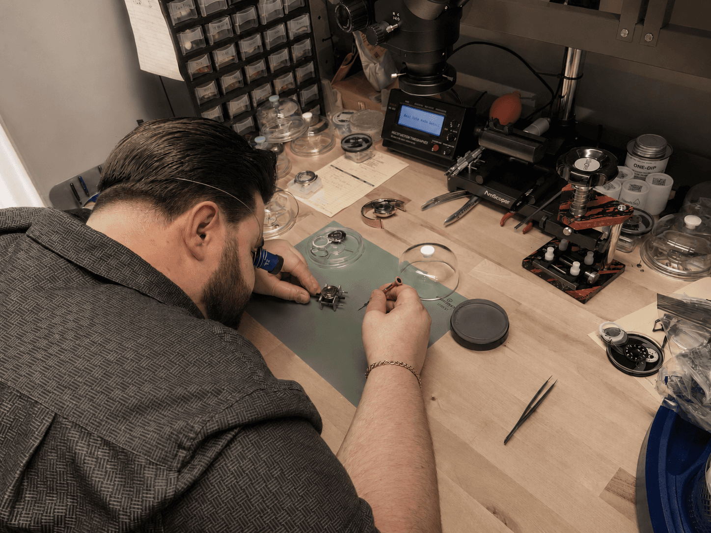 Watchmaker servicing a mechanical watch movement by hand at Asbury Park Watches, 511 Cookman Ave, Asbury Park, NJ